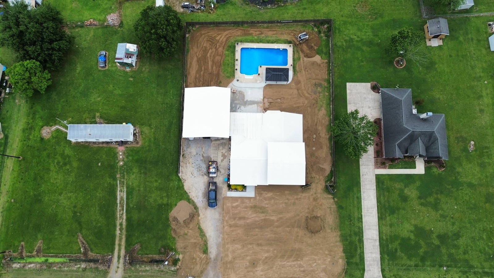 Aerial view of freshly cleaned metal roofs on an Acadiana property