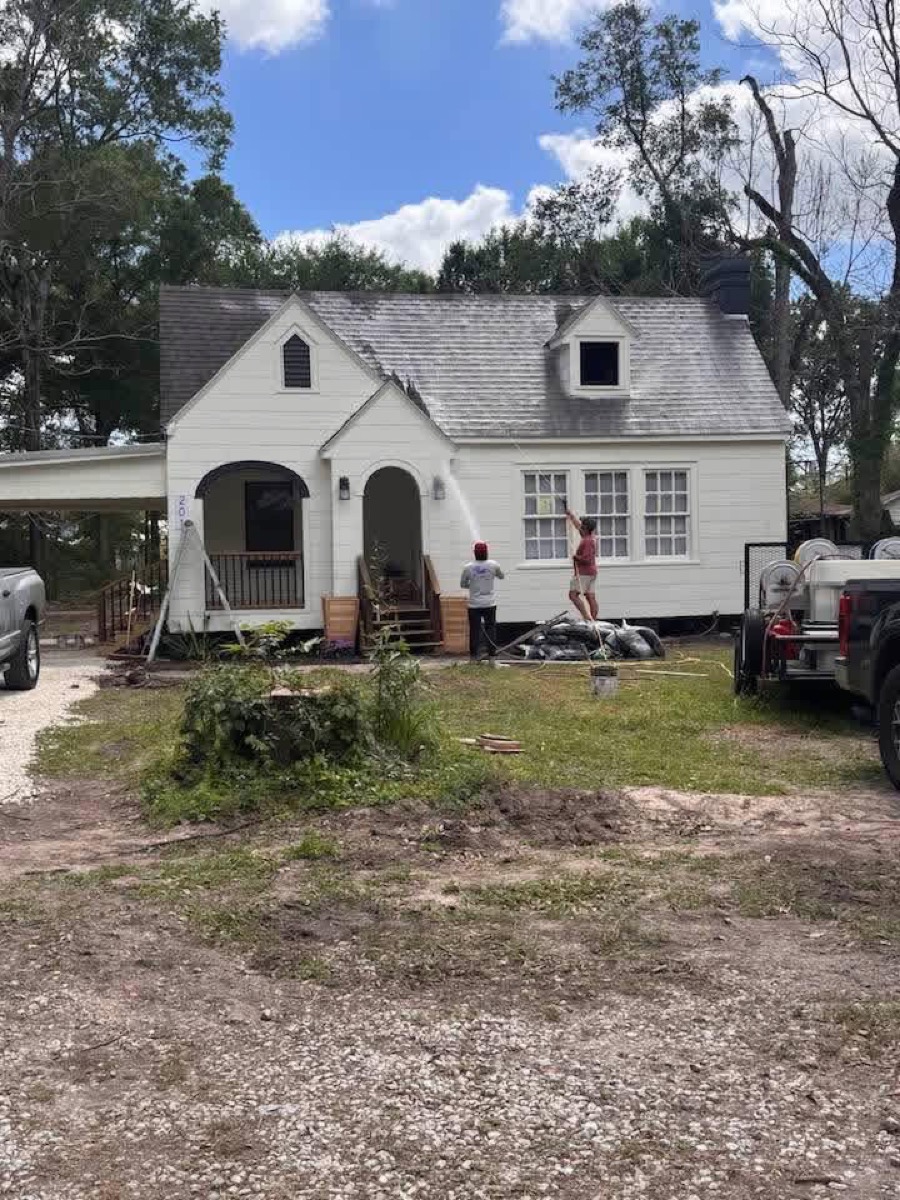 All American Pressure Washing crew soft washing a home exterior