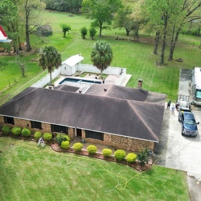Aerial view of a roof with black algae streaks before soft washing